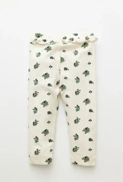Białe legginsy niemowlęce w kwiatuszki z materiału pointelle